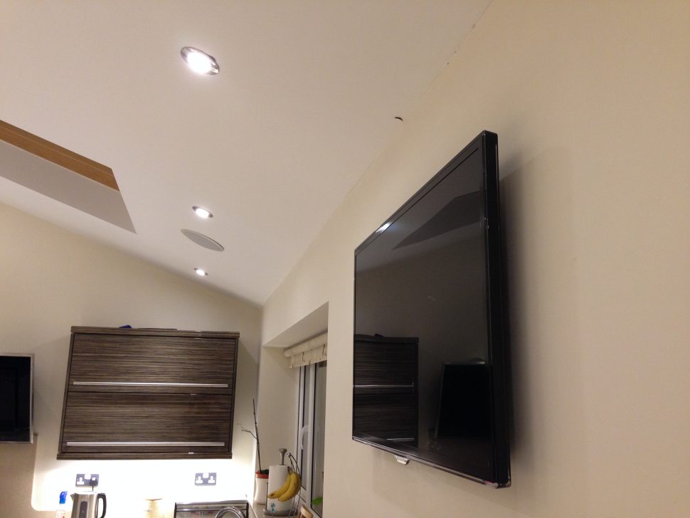 Flat screen TV installed with ceiling speakers
